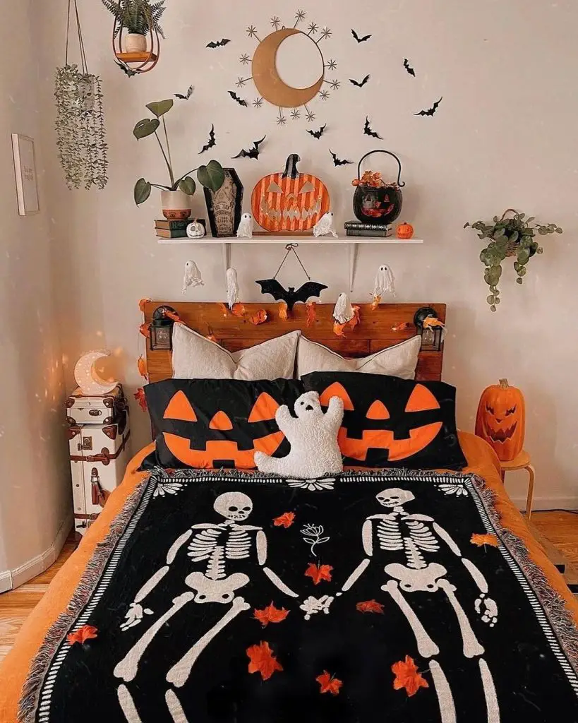 Halloween-themed bedroom with skeleton blanket pumpkin pillows and ghostly decorations