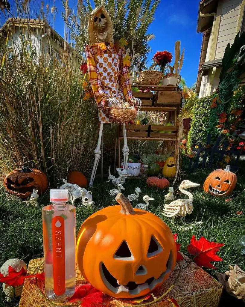 Skeleton farmer surrounded by pumpkins small skeleton animals and Halloween decorations in sunny garden