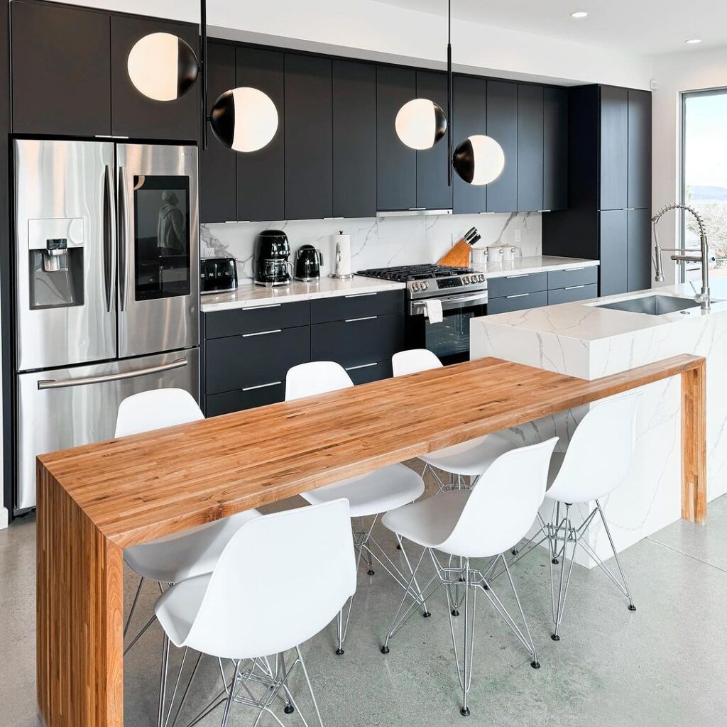 Modern kitchen with black cabinets and wood bar