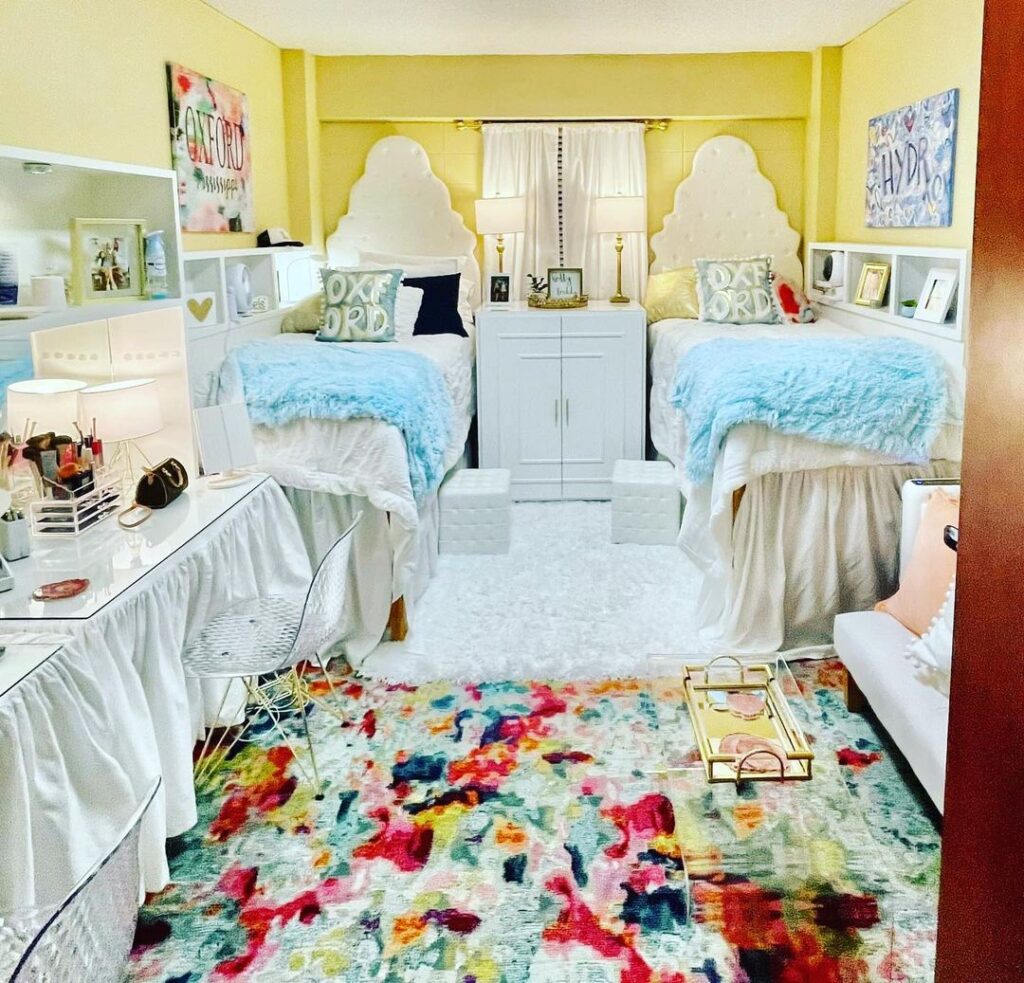 Bright dorm room with twin beds colorful rug and yellow walls