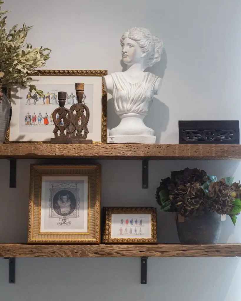 Rustic shelves with bust statue and vintage prints