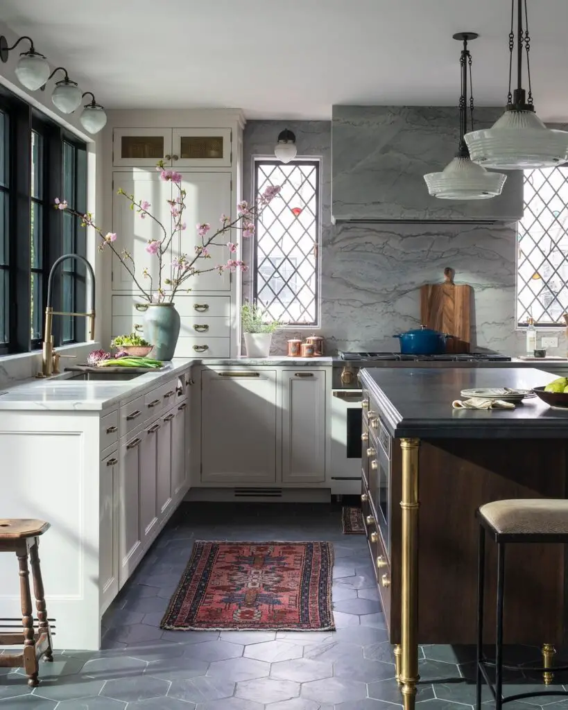 Elegant kitchen with cream cabinets, marble backsplash, and vintage windows