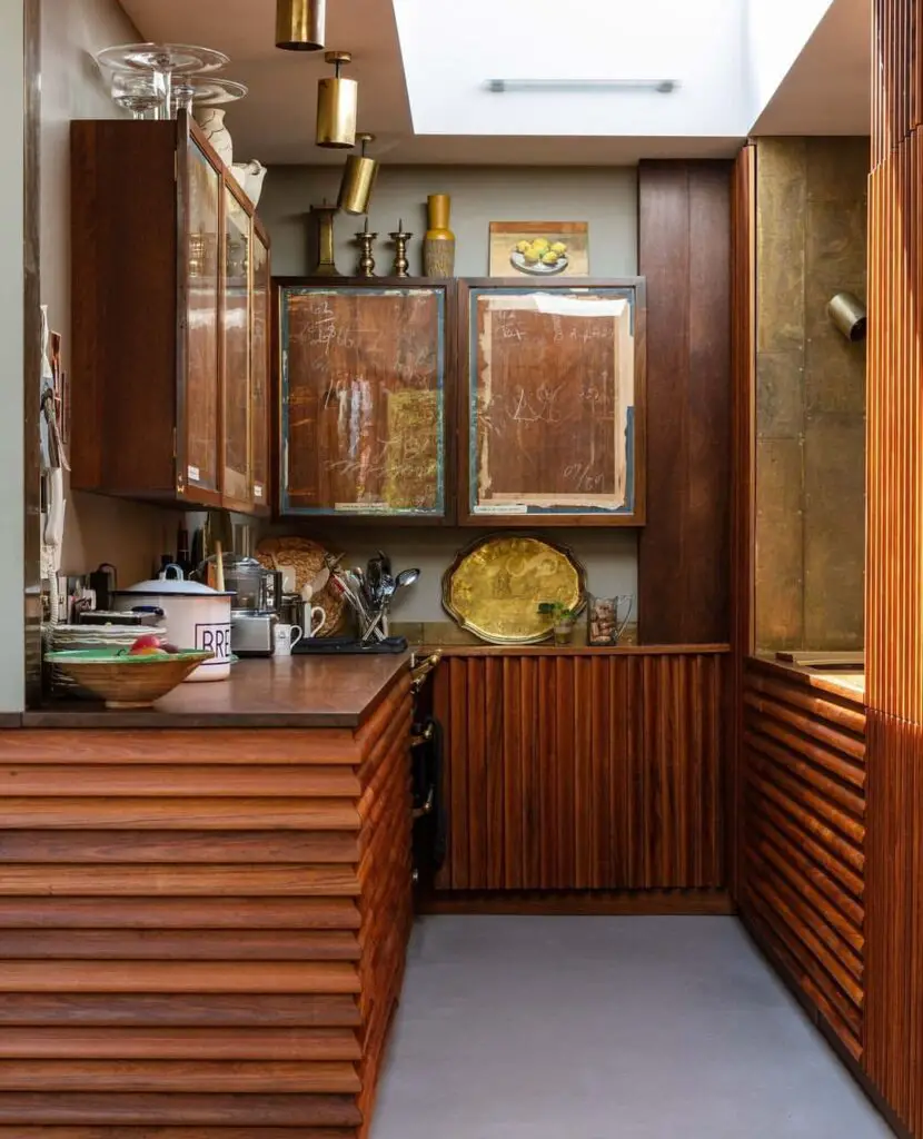 Wooden kitchen with vintage cabinet doors and brass accents