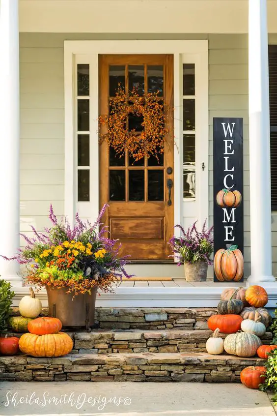 Autumn decorated porch with wreath and pumpkins