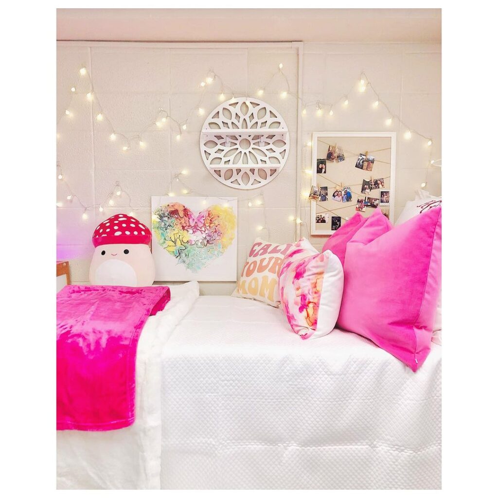 Dorm room with pink decor fairy lights and quirky accessories