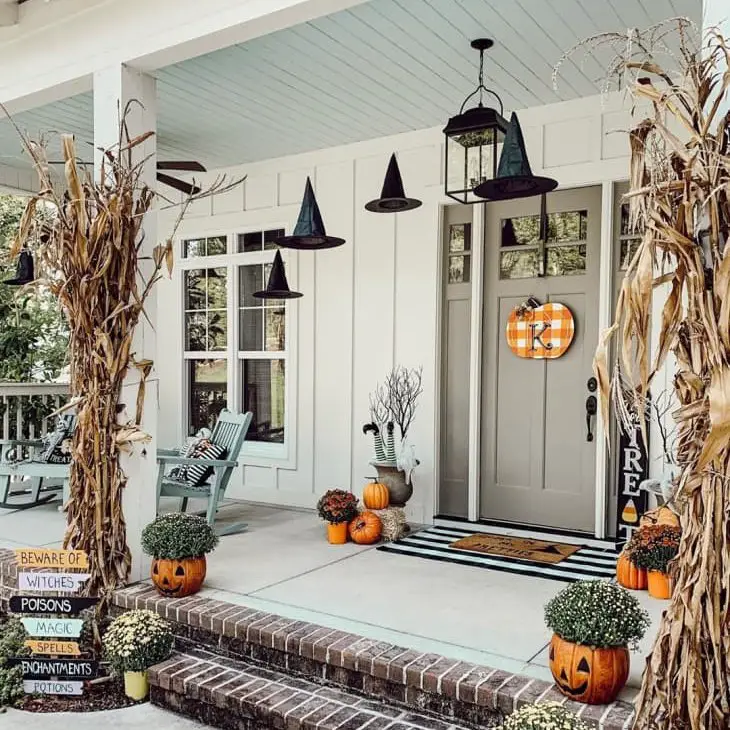 Halloween-themed porch with witch hats and pumpkins