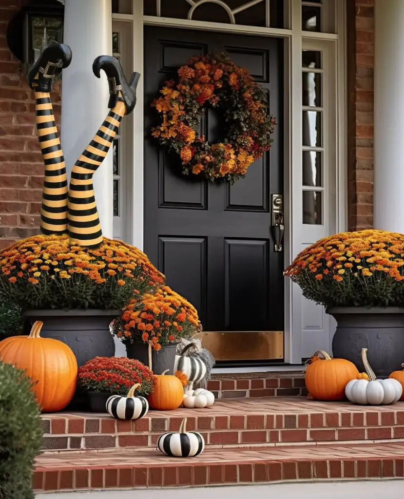 Elegant porch with witch leg decorations mums and pumpkins