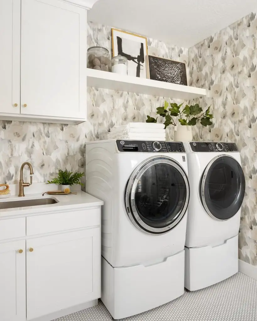 Stylish laundry room with watercolor wallpaper accents.