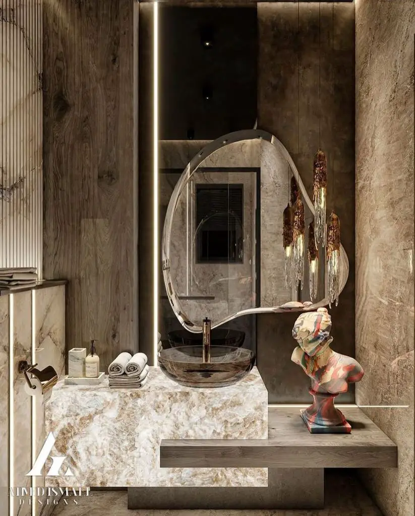 Modern stone bathroom with artistic mirror and sculptural elements