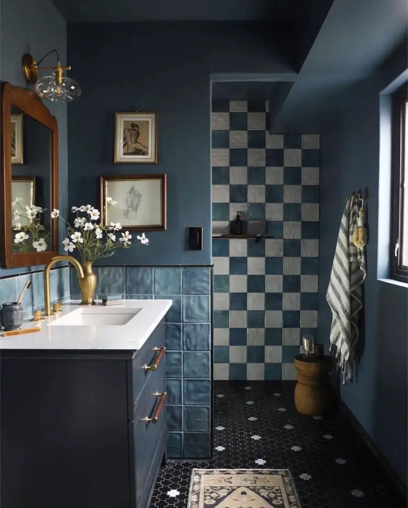 Dark blue bathroom with art and checkered tiles