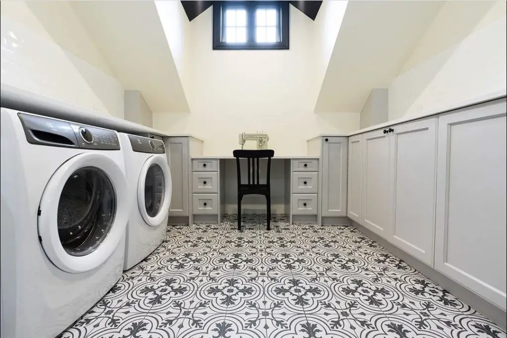 Attic laundry room with patterned floor tiles