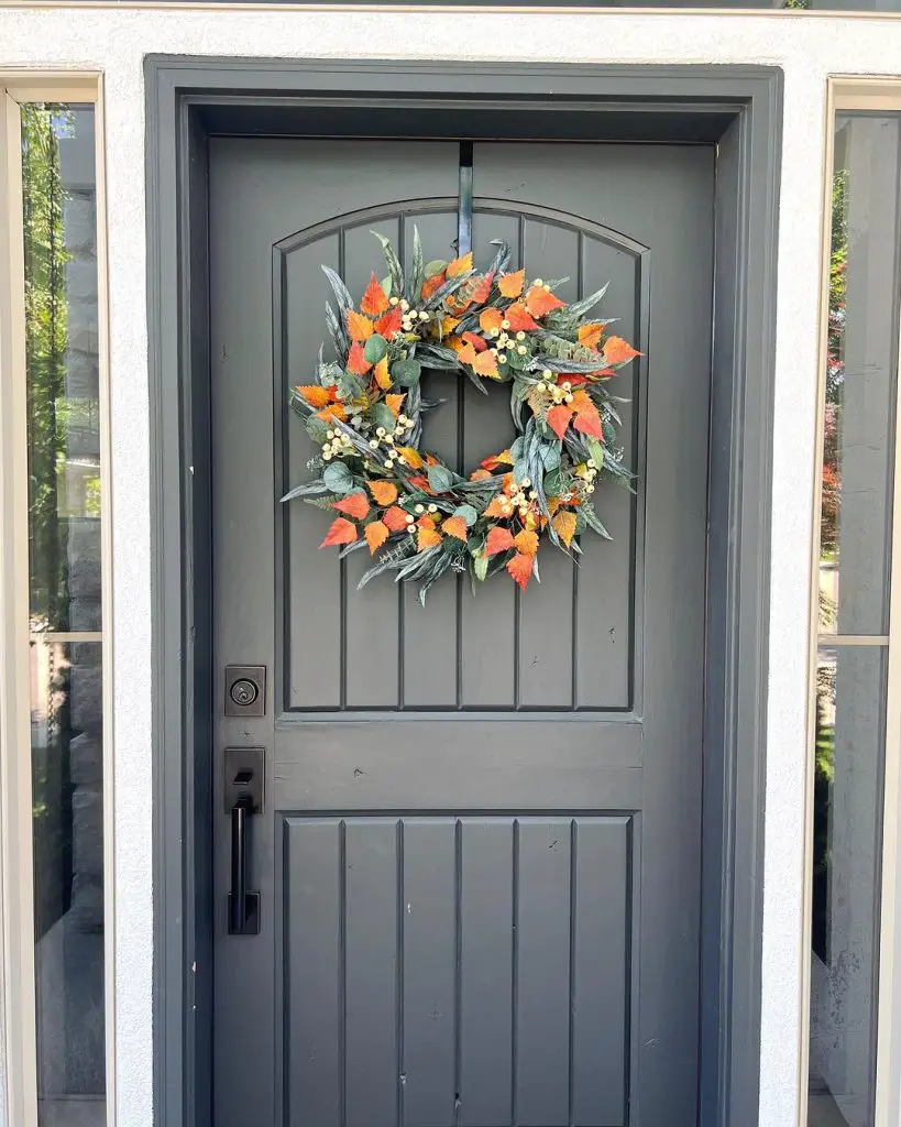 Colorful fall wreath on gray front door