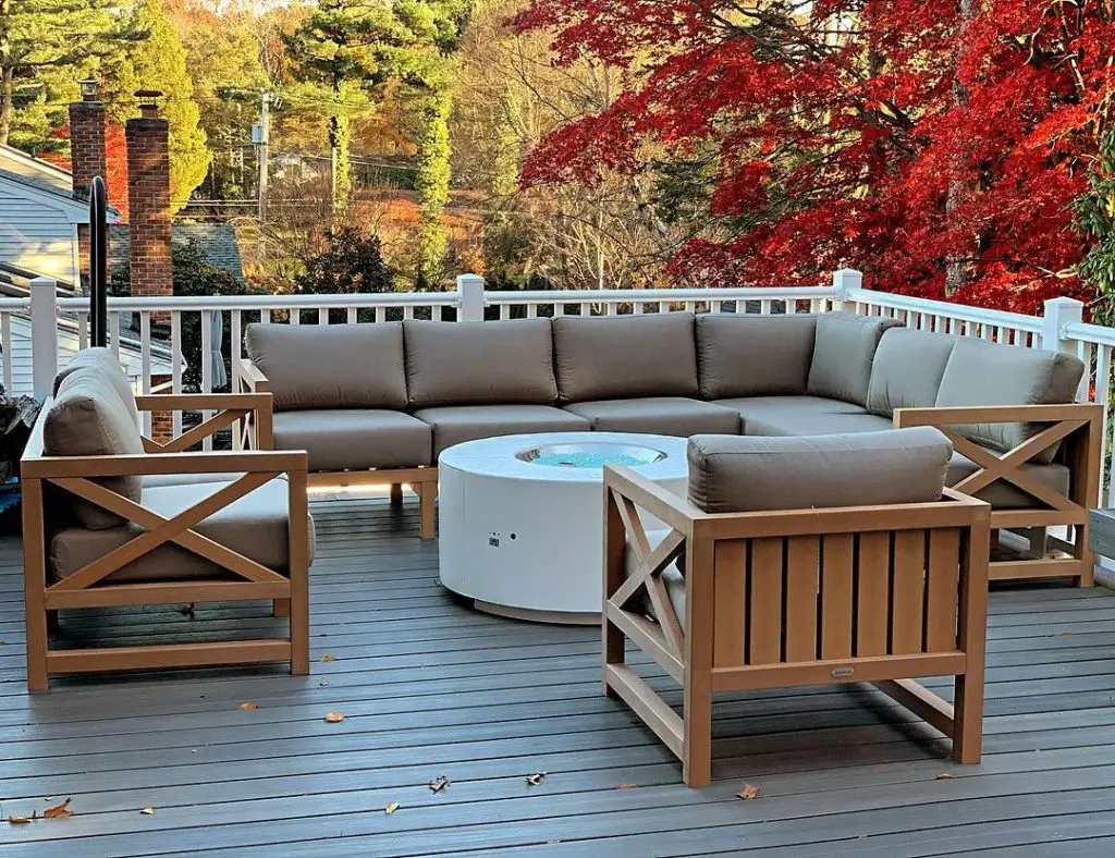 Deck with large sofa fire pit and autumn foliage view