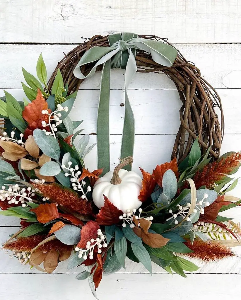 Wreath with white hydrangea and cascading pink berries