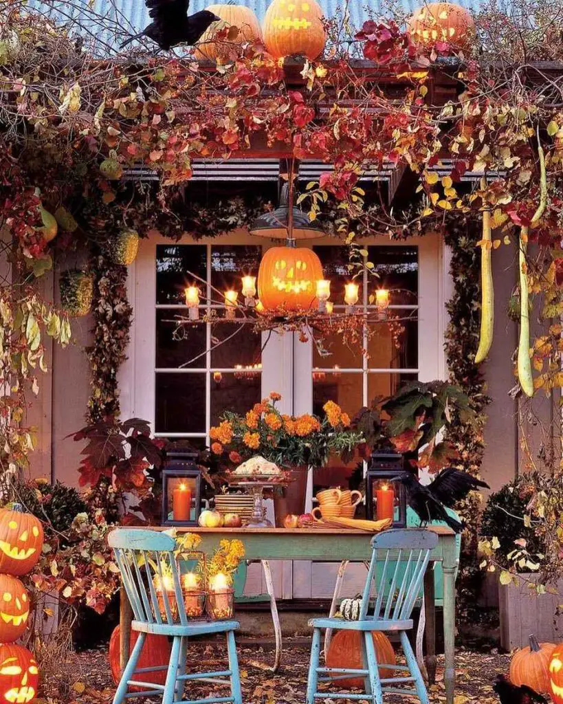 Festive Halloween porch with pumpkins table and autumn decor