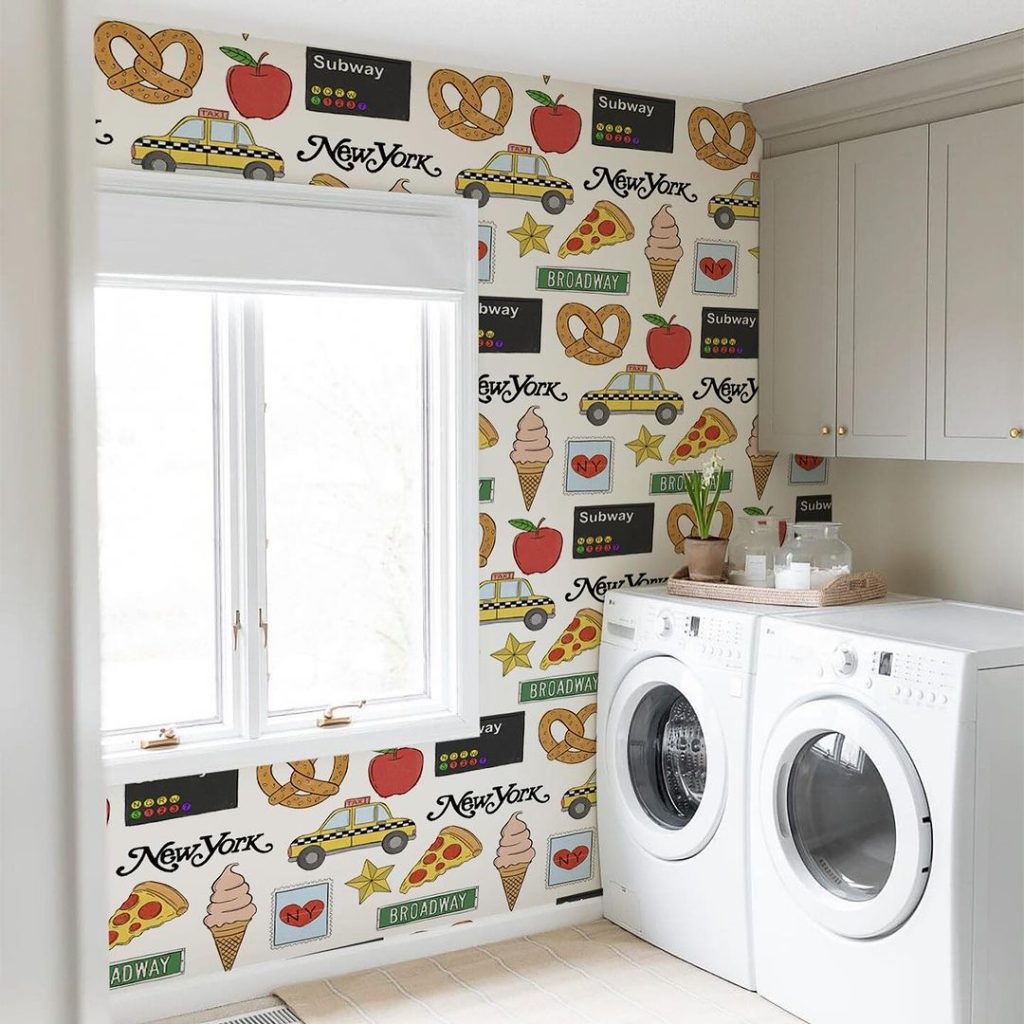 Laundry room with New York-themed wallpaper and white appliances.