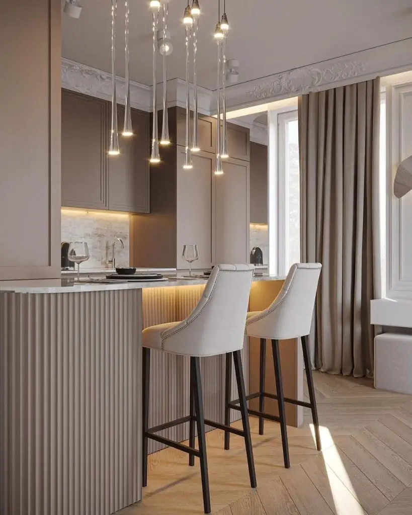 Modern kitchen with hanging lights and white barstools