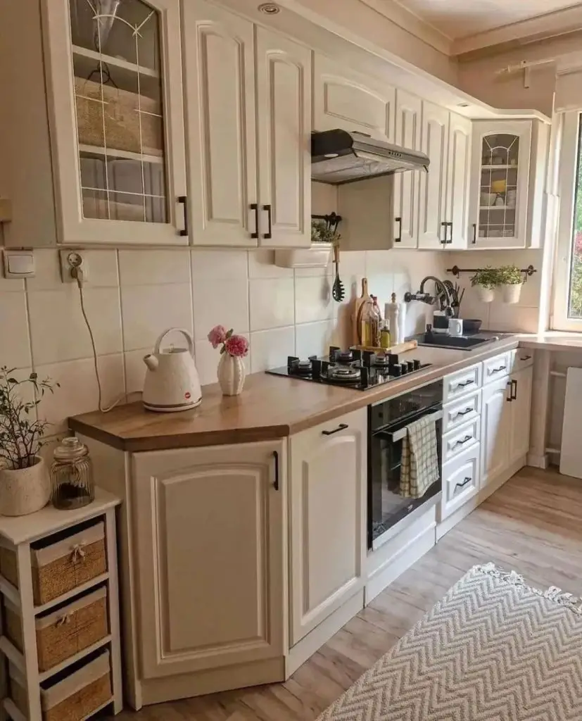 Bright kitchen with white cabinets and wood countertops