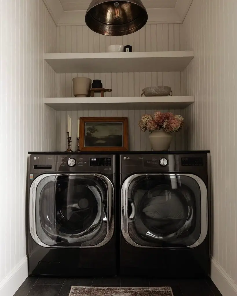 Cozy laundry nook with black appliances and rustic decor