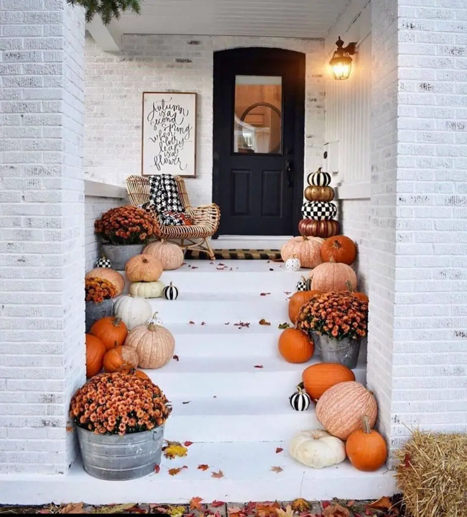 White porch with pumpkins and buffalo check accents