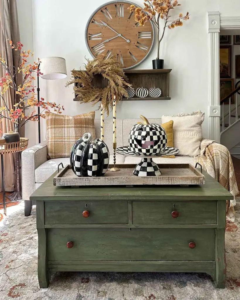 Living room with checkered pumpkins and vintage green dresser