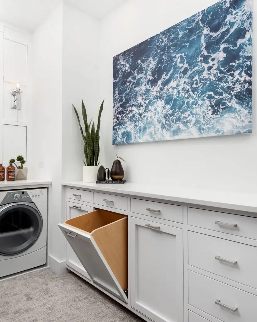 White laundry room with ocean wave artwork and built-in storage