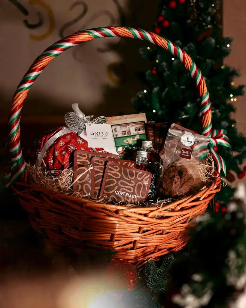 Wicker Christmas basket with coffee treats and festive decorations