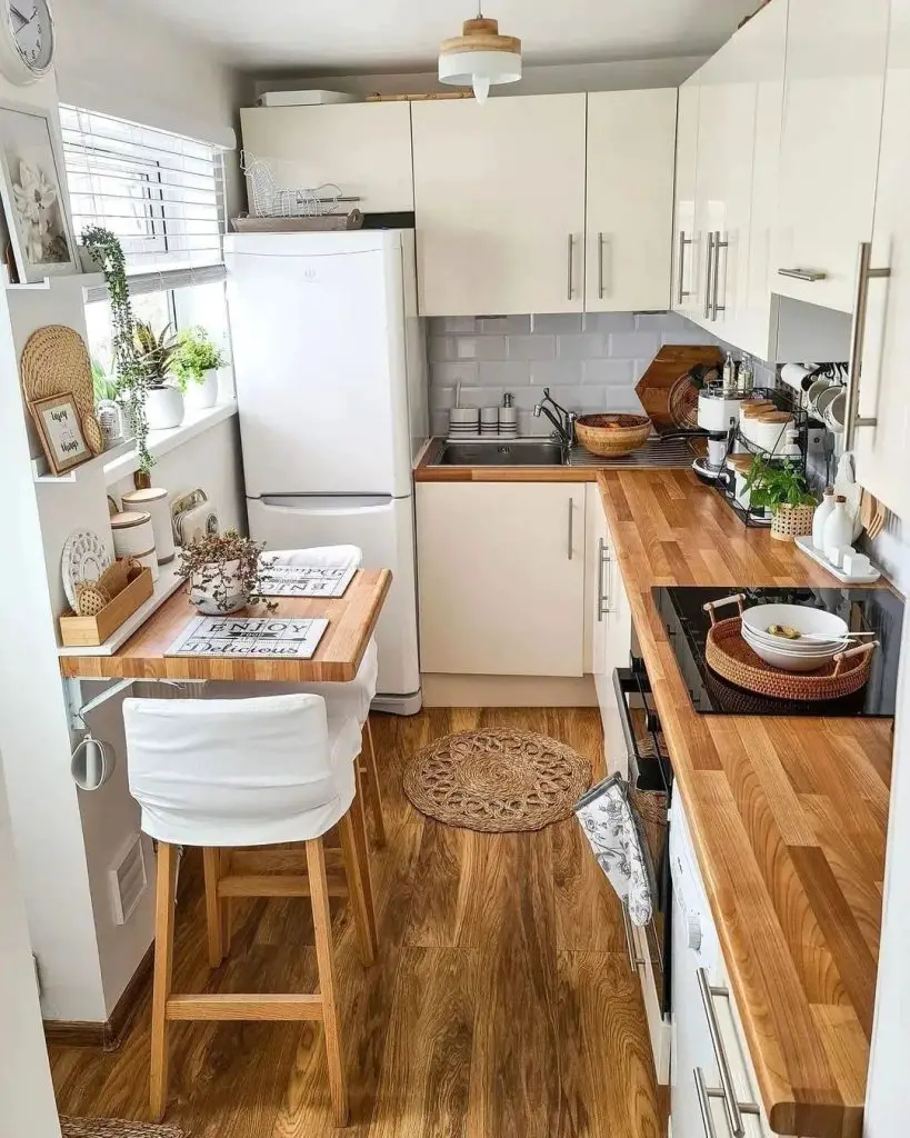 Small kitchen with white cabinets and wooden countertops