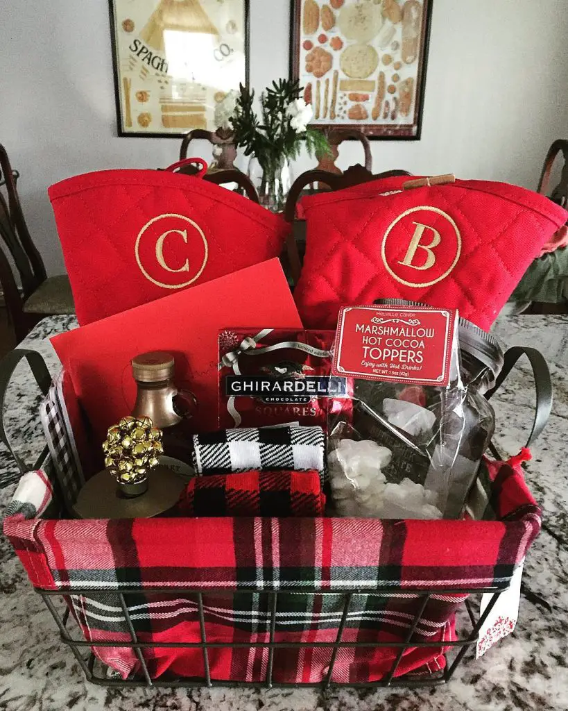 Plaid gift basket with personalized totes, chocolates, and holiday treats for a couple.