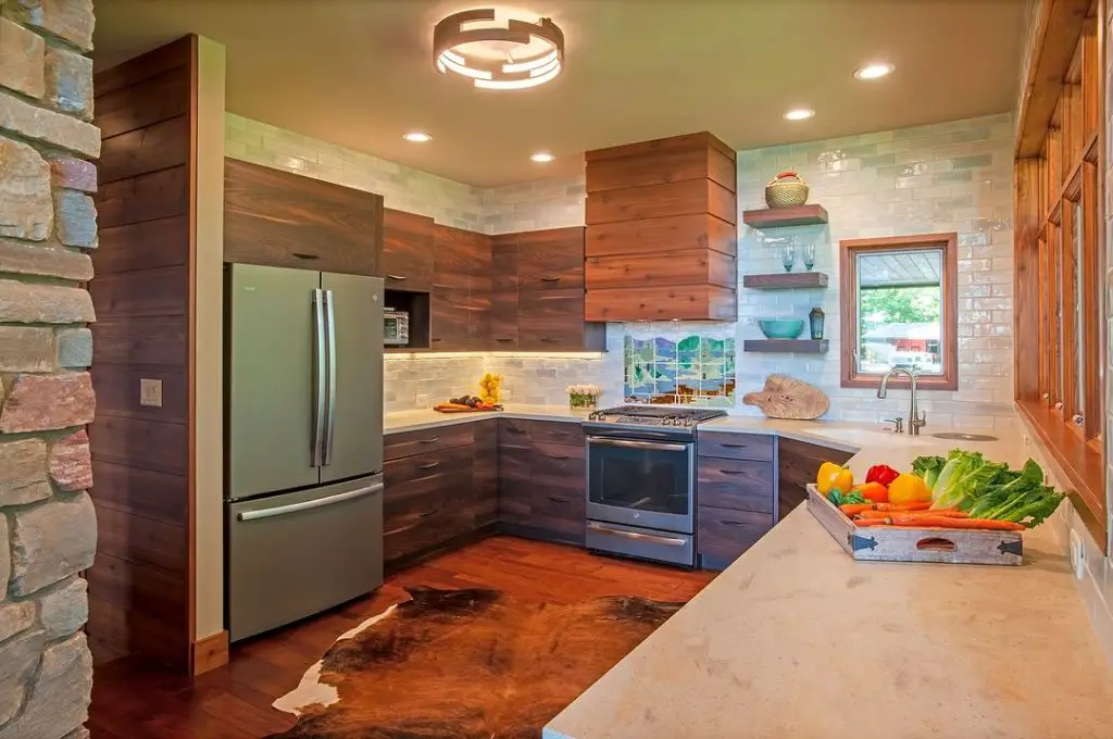 Modern rustic kitchen with wood cabinets and stone wall