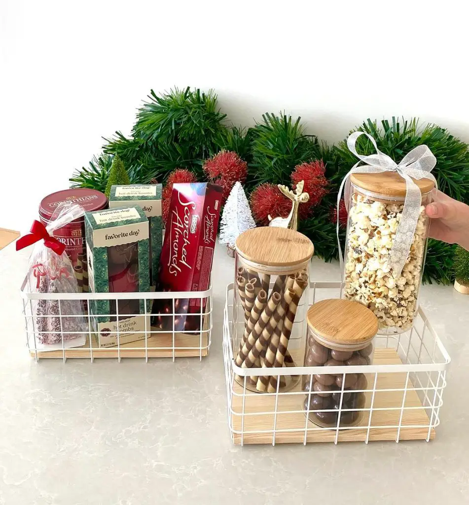 Christmas gift baskets with snacks drinks and decorations