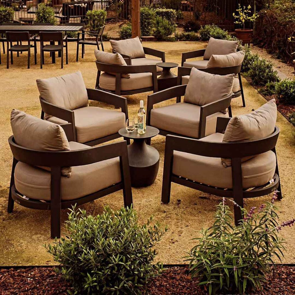 Modern outdoor lounge chairs on desert patio with plants