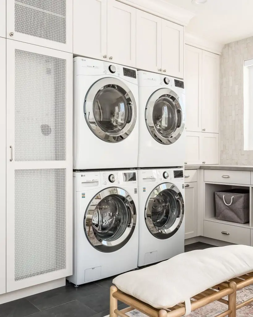 Luxurious laundry room with stacked washers and dryers