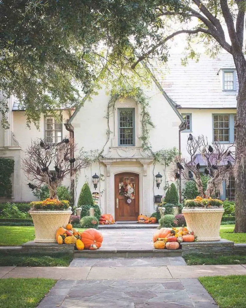 Elegant house entrance decorated with pumpkins and Halloween decor