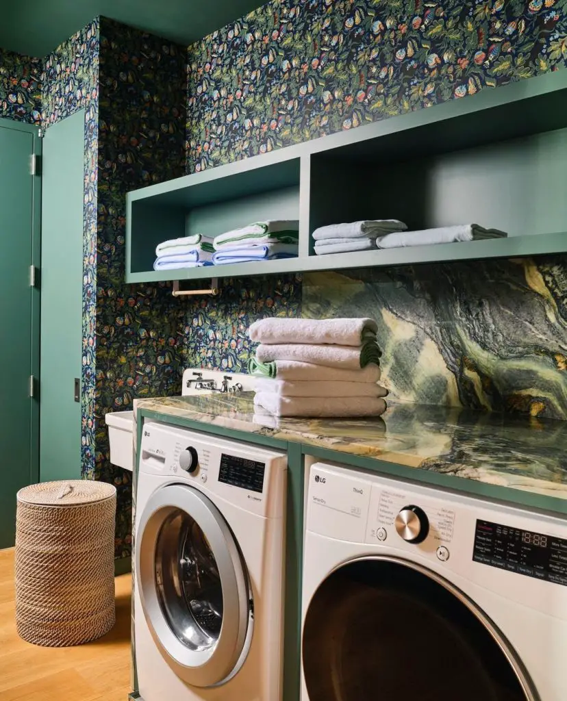 Laundry room with floral wallpaper and green accents.