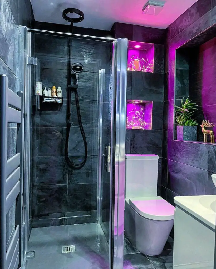 Modern bathroom with purple lighting and glass shower.