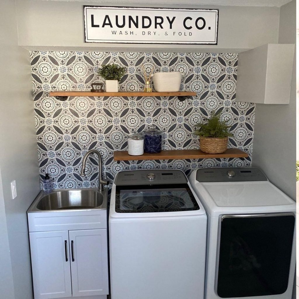 Laundry room with geometric wallpaper and modern appliances