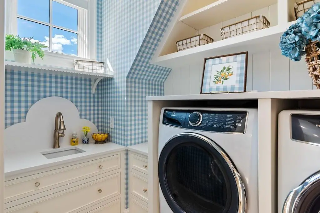 Cozy blue gingham laundry room with modern appliances.