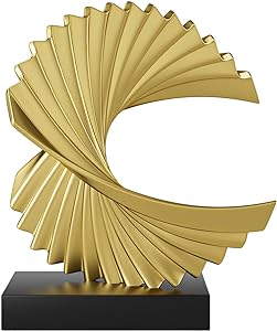 .A golden, spiral-shaped sculpture with overlapping, angular folds sits on a black rectangular base.