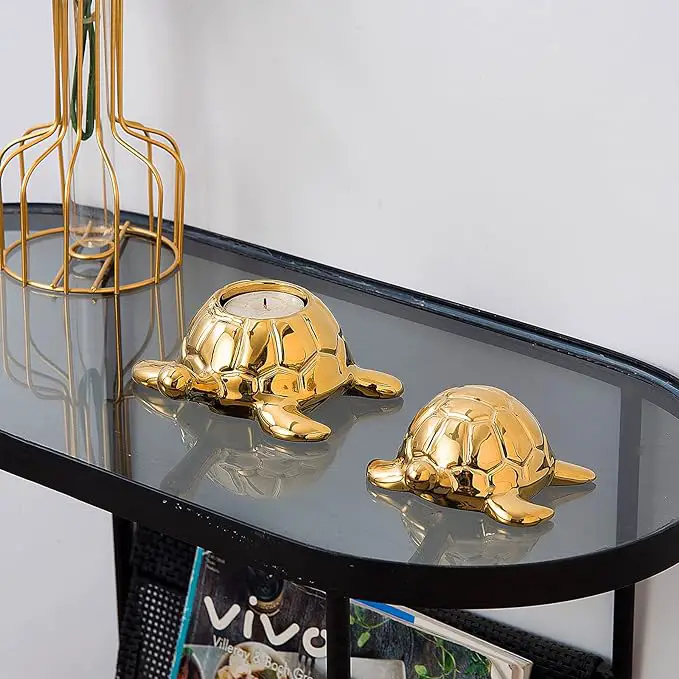A decorative glass table holds two golden turtle figurines.