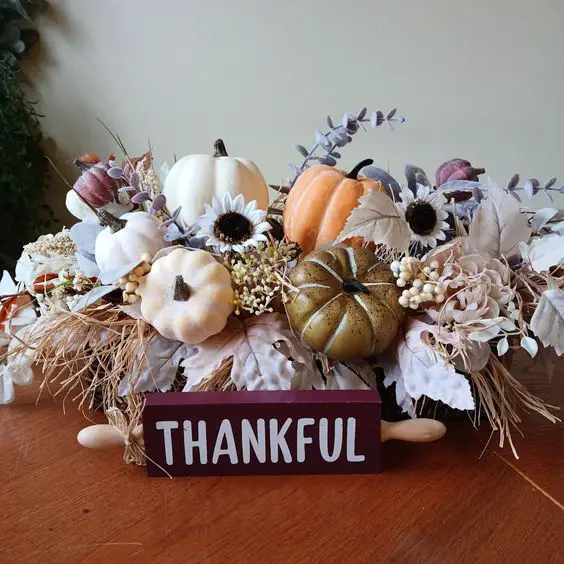 Thankful sign with pumpkins and fall flowers