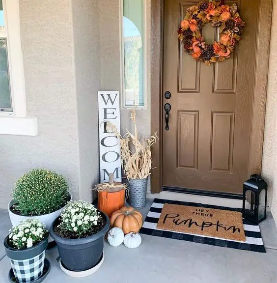 Festive fall porch with wreath and pumpkins