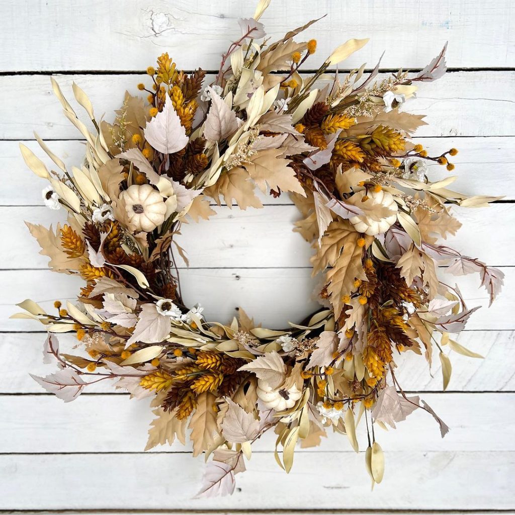 Neutral fall wreath with dried flowers and pumpkins