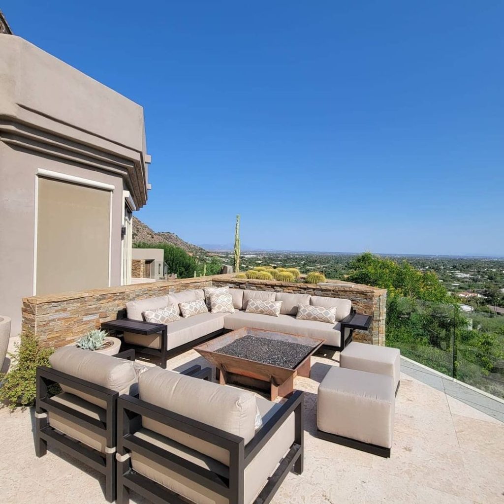 Luxurious outdoor lounge set on hilltop overlooking desert valley
