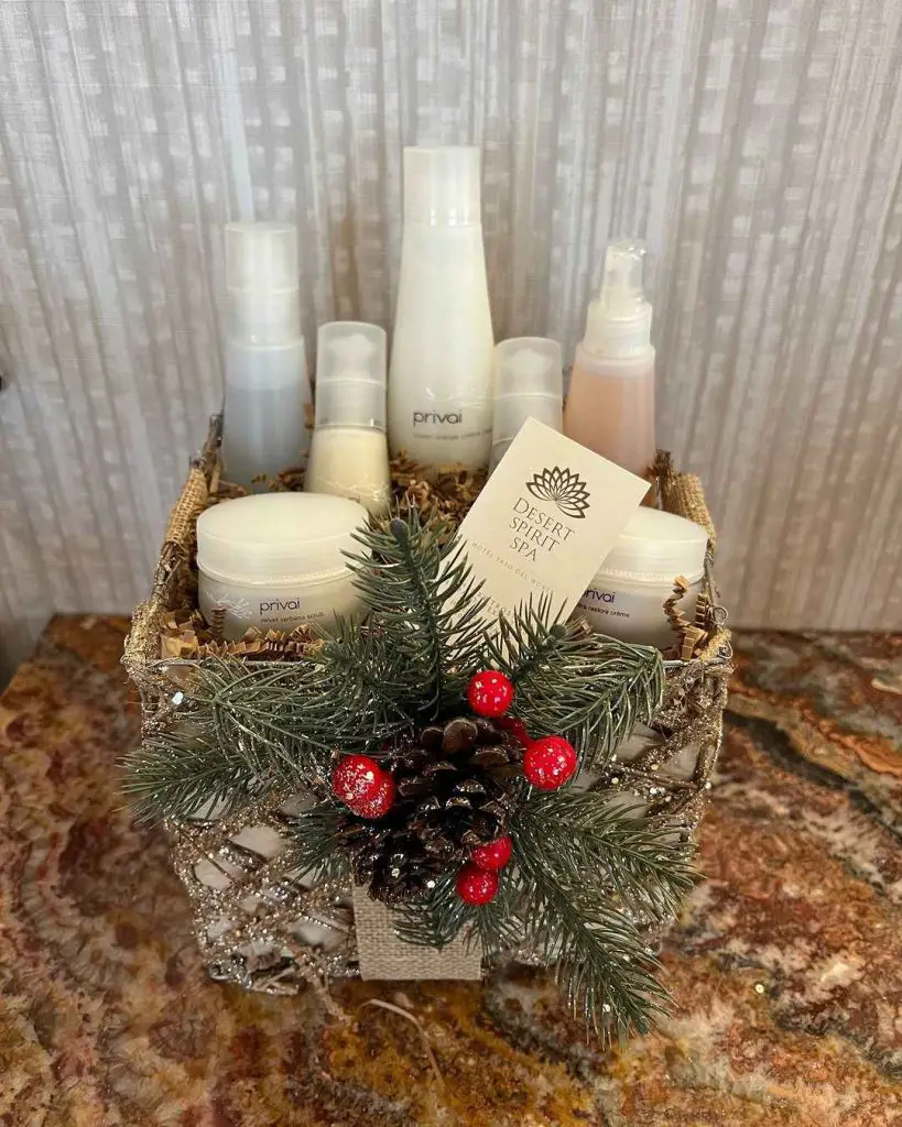 Spa gift basket with skincare products and holiday decorations.