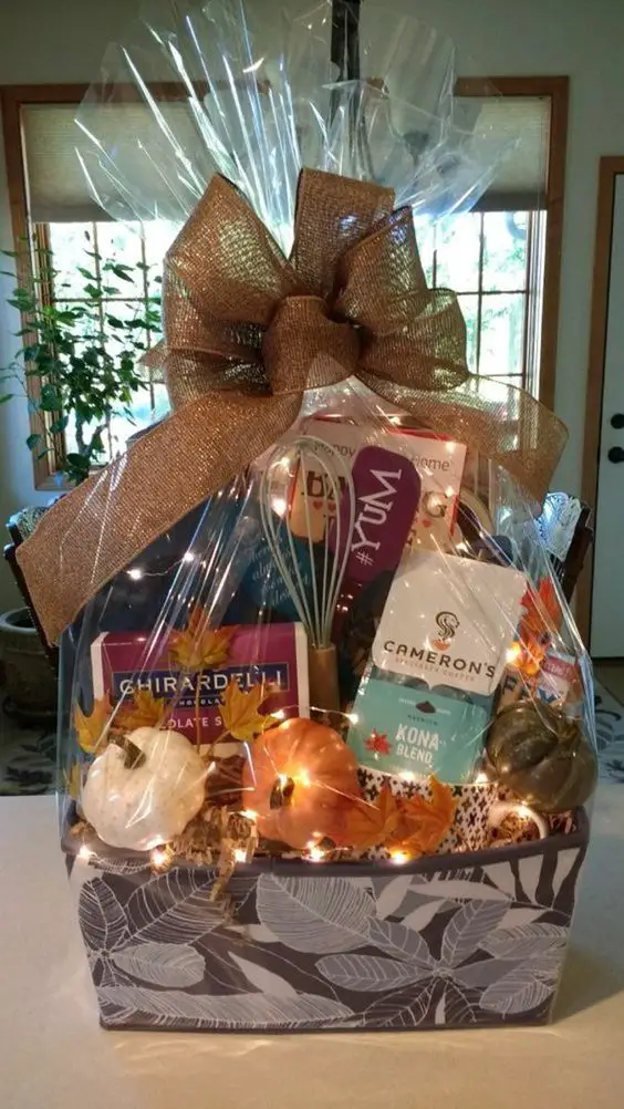 Gift basket with lights chocolates and autumn decorations