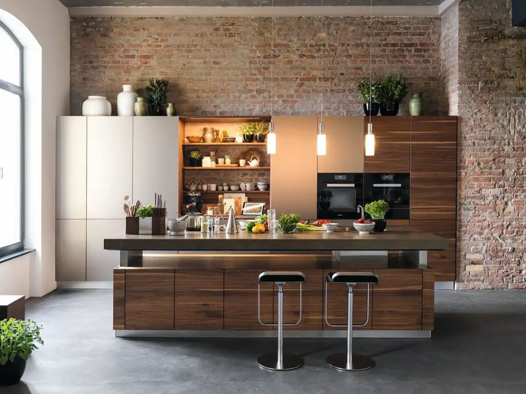 Modern kitchen with exposed brick walls and wooden island