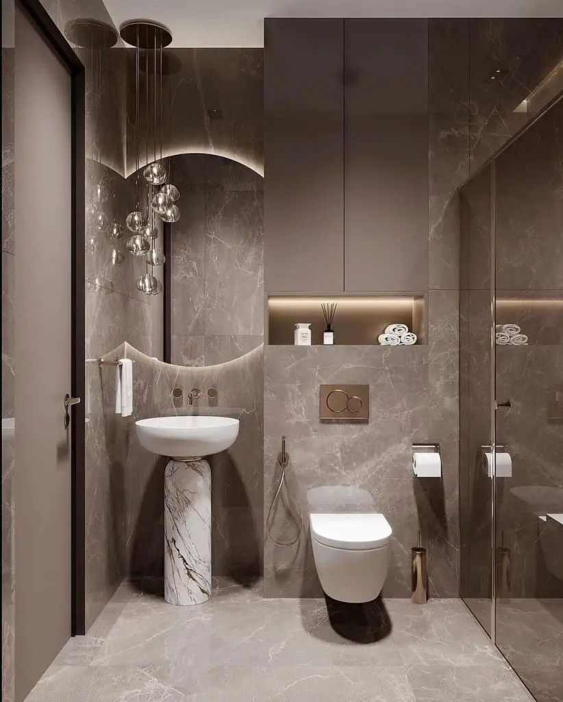Modern grey marble bathroom with pedestal sink and glass lights
