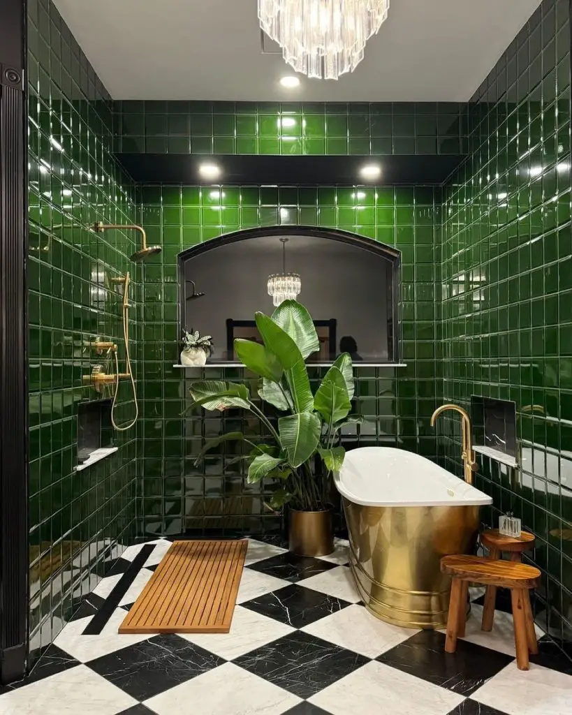 Luxurious green-tiled bathroom with gold bathtub