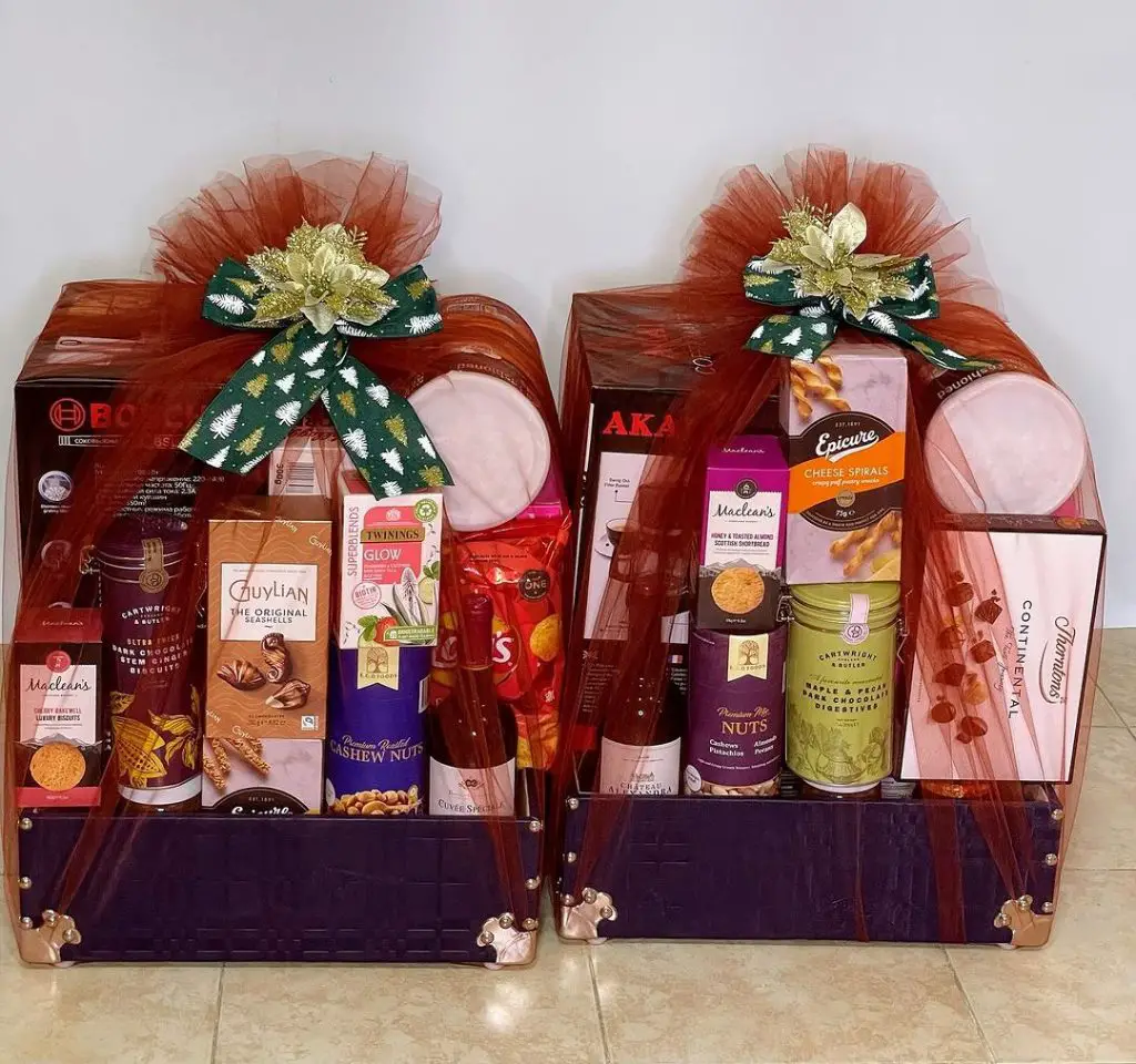 Two festive gift hampers filled with gourmet foods and drinks